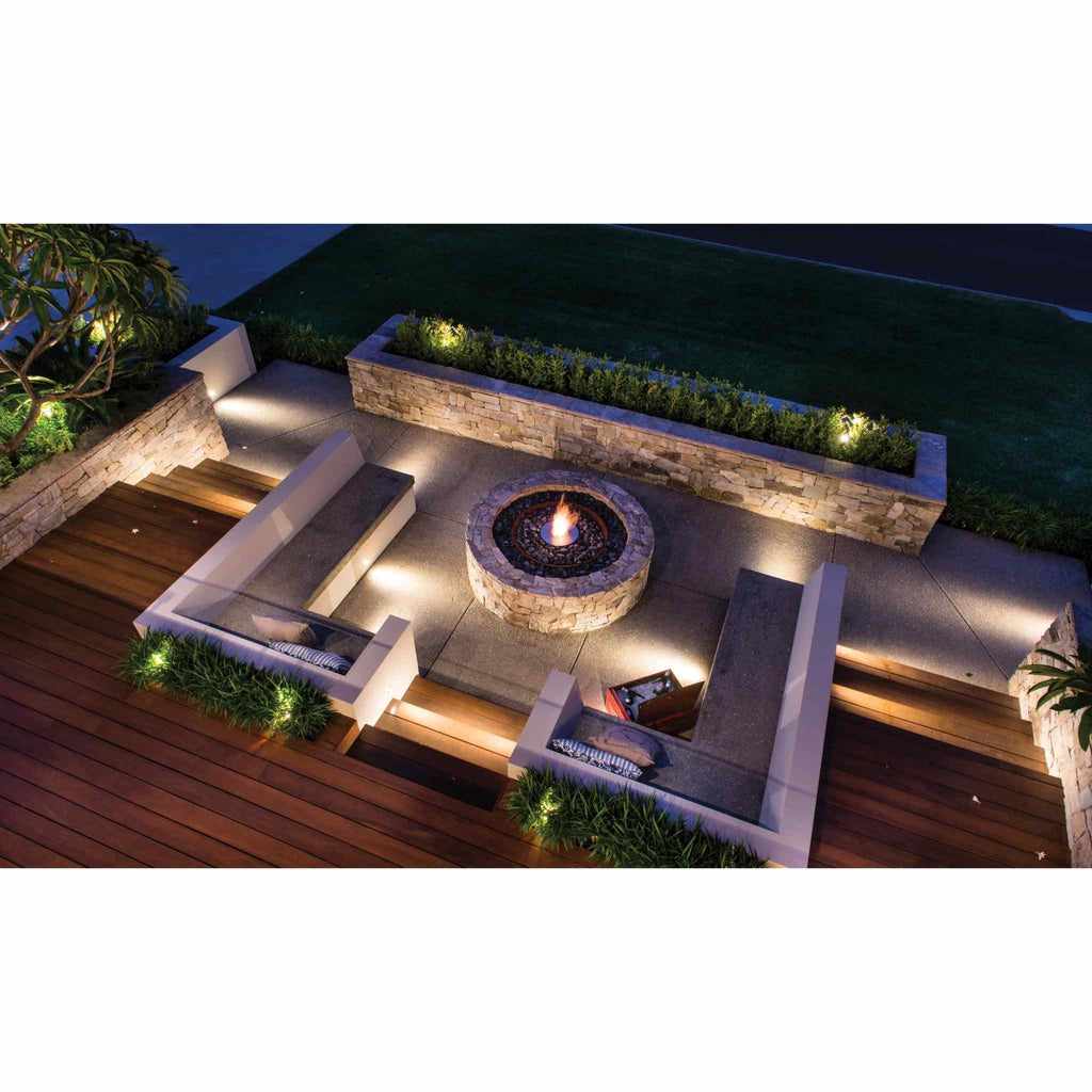 EcoSmart Fire AB8 Ethanol Burner set in a circular stone fire pit on a modern outdoor patio with wooden decking.