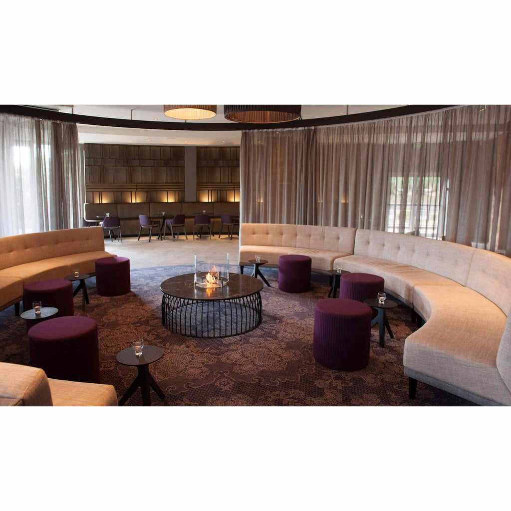 EcoSmart Fire AB8 Ethanol Burner with top tray integrated into a circular coffee table in a lounge setting.
