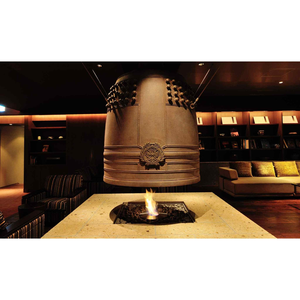 EcoSmart Fire AB8 Ethanol Burner set in a square stone table beneath a large, suspended bronze-coloured temple bell.