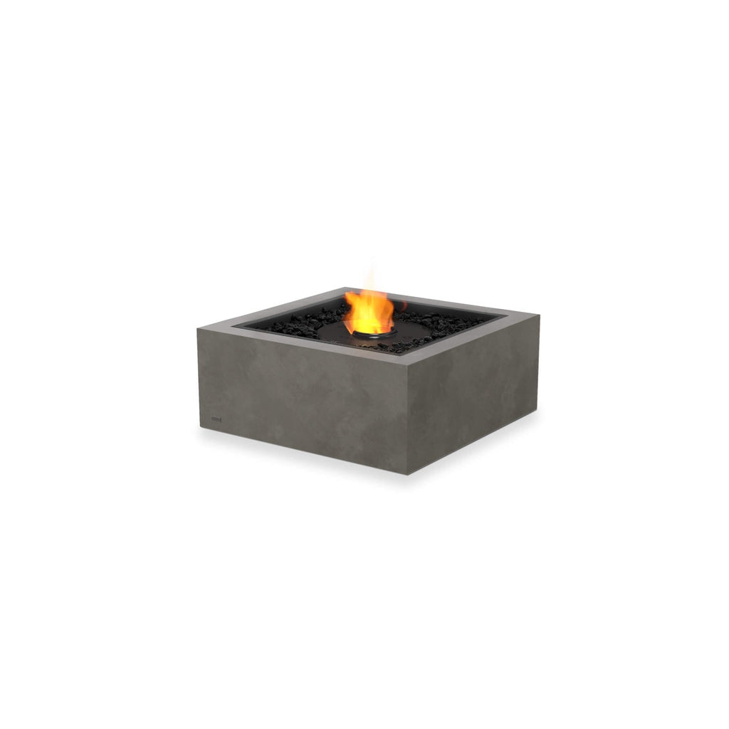EcoSmart Fire Base 30 square grey concrete fire pit table with a central flame and black decorative stones.