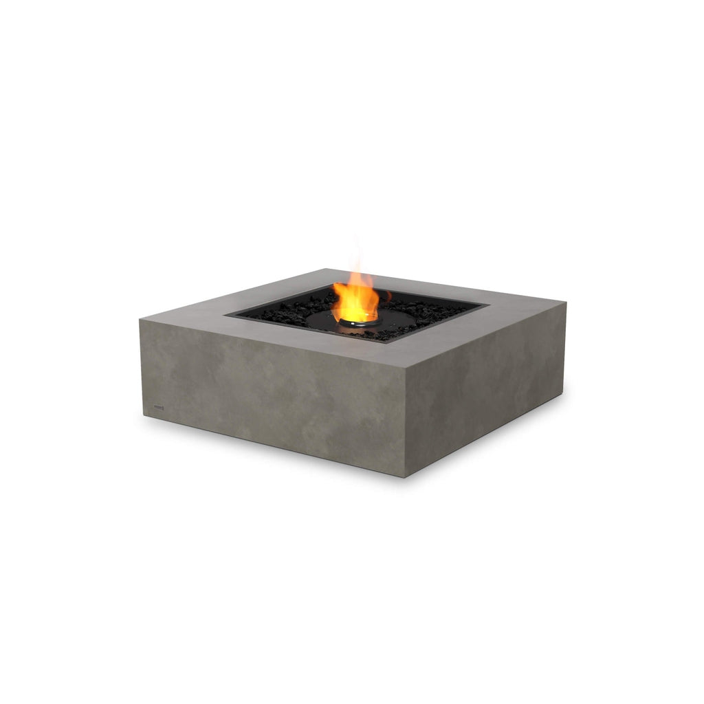 EcoSmart Fire Base 40 square concrete-style fire pit table with a central flame and black decorative stones.