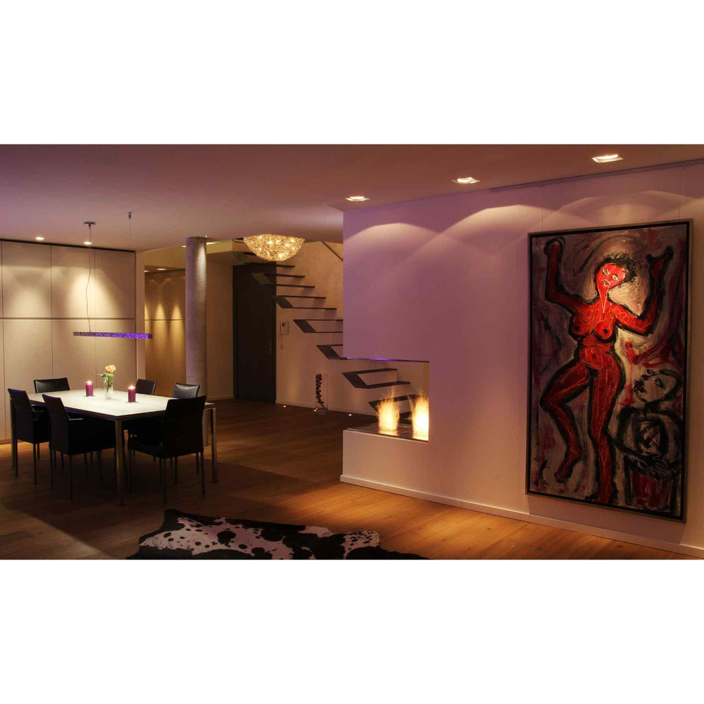 EcoSmart Fire BK5 ethanol burner integrated into a modern staircase wall, featuring a warm flame in a minimalist home.