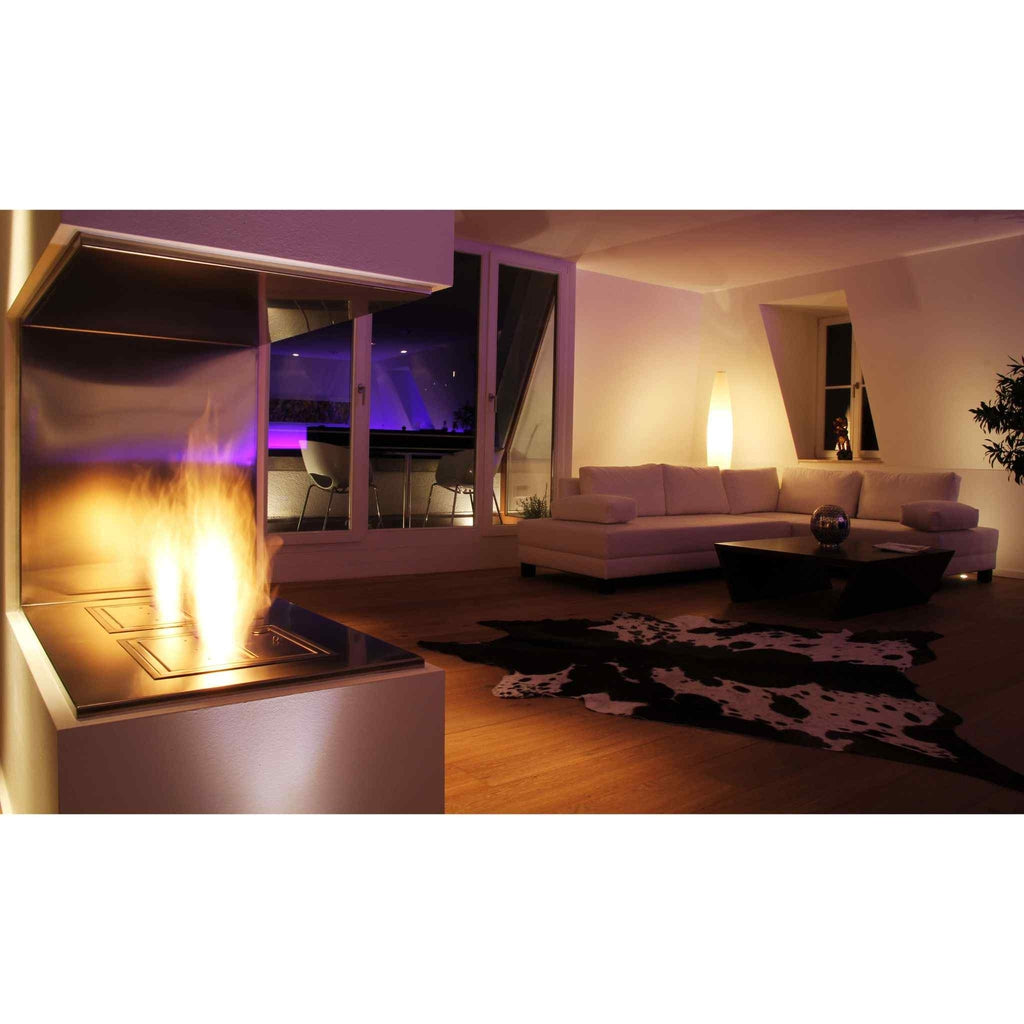 EcoSmart Fire BK5 ethanol burner with a stainless steel finish, glowing with a flame in a modern living room.