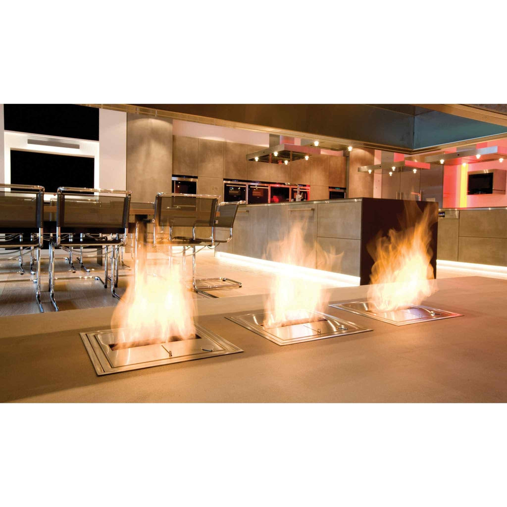 Three stainless steel EcoSmart Fire BK5 ethanol burners inset into a floor, producing bright orange flames.