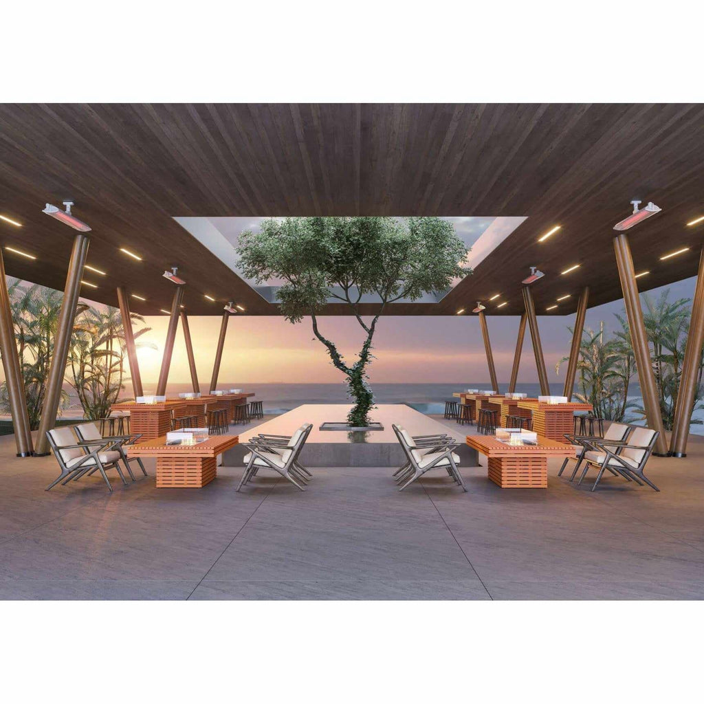 EcoSmart Fire Gin 90 bioethanol fire pit tables arranged in a modern, open-air seaside lounge at sunset.
