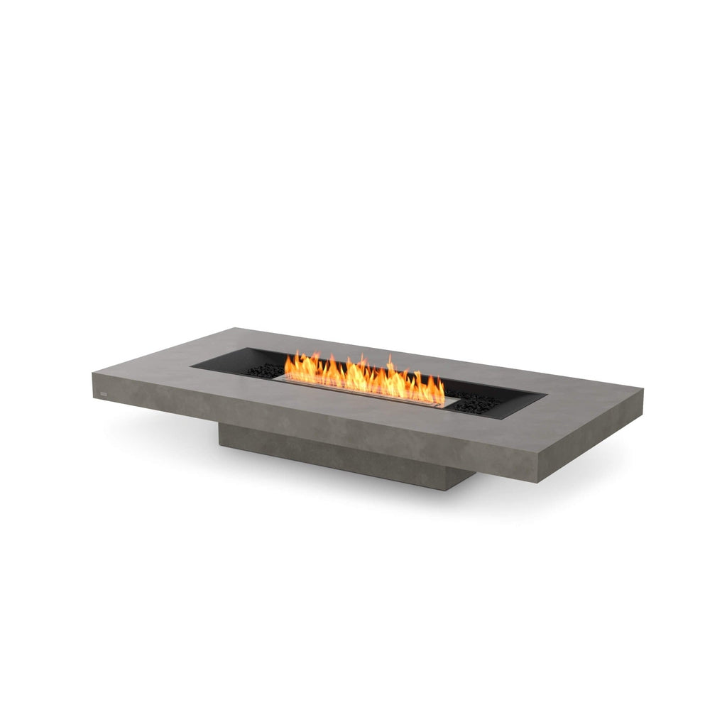 EcoSmart Fire Gin 90 low rectangular grey concrete fire pit table with a central linear flame and black pebbles.