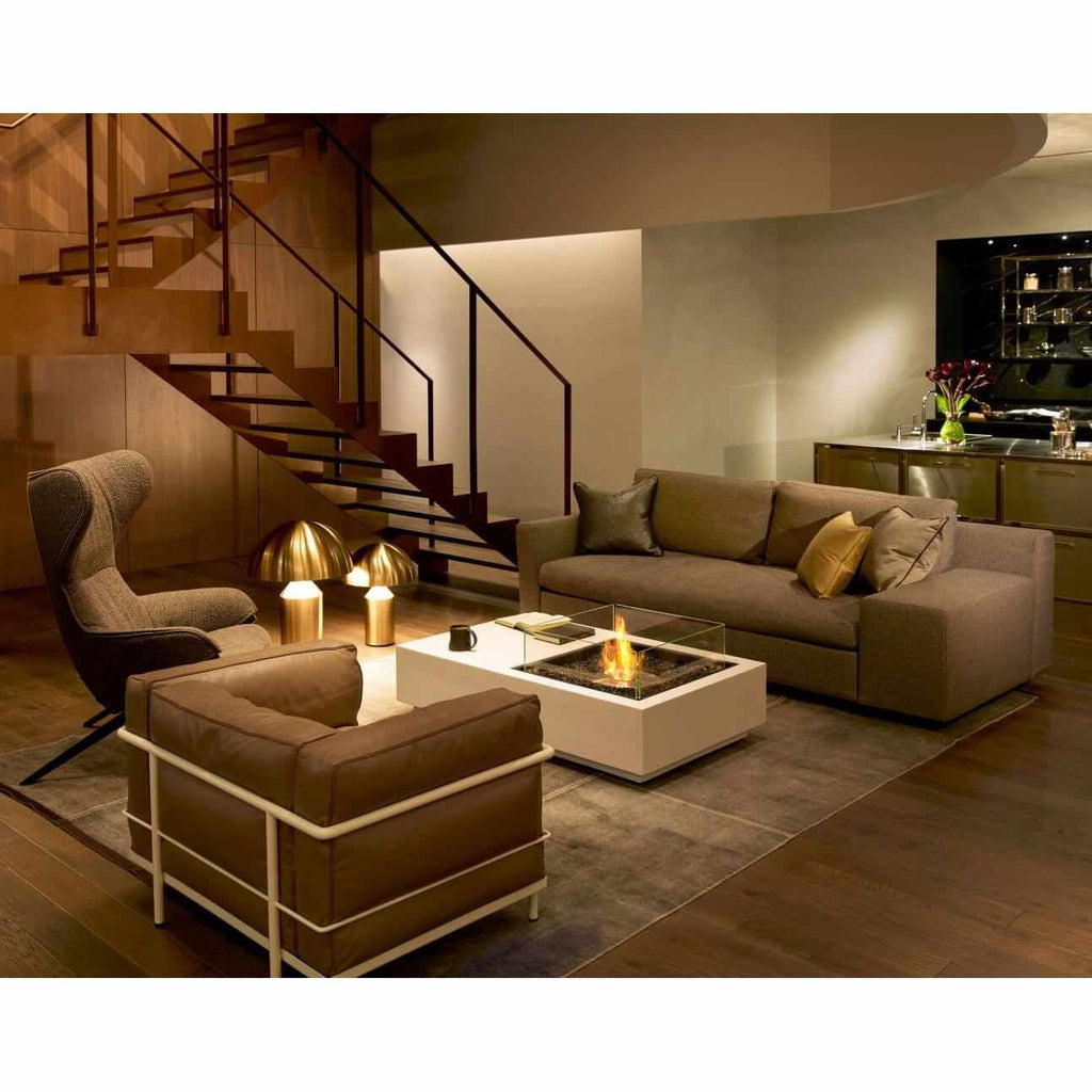 EcoSmart Fire Manhattan 50 bioethanol fire pit table with a white square base in a modern living room setting.