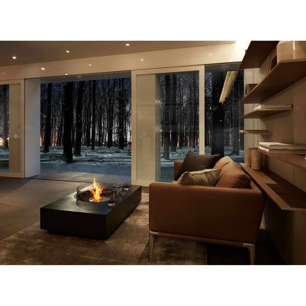 EcoSmart Fire Martini 50 bioethanol fire pit table in black, featuring a central flame in a modern living room.