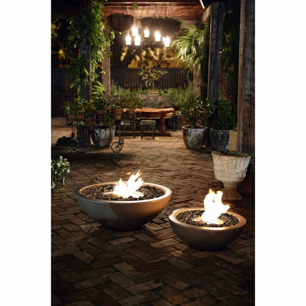 Two EcoSmart Fire Mix 600 bioethanol fire bowls in a concrete finish, glowing with flames on a brick patio at night.