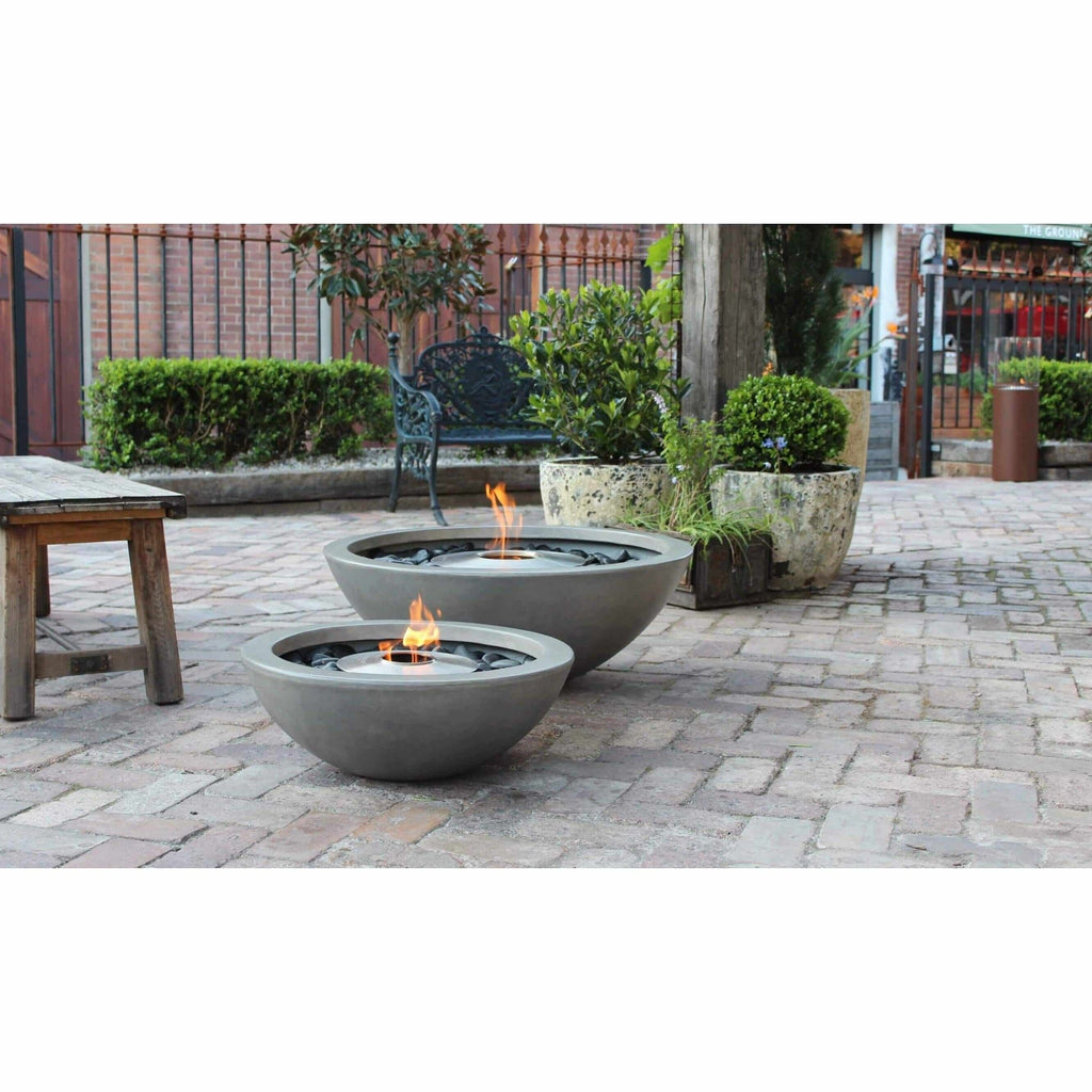 Two grey concrete EcoSmart Fire Mix 600 bioethanol fire pit bowls with central flames on a paved patio.