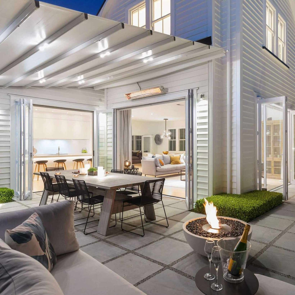 EcoSmart Fire Mix 850 bioethanol fire pit bowl with a concrete finish and glowing flame on a modern patio.