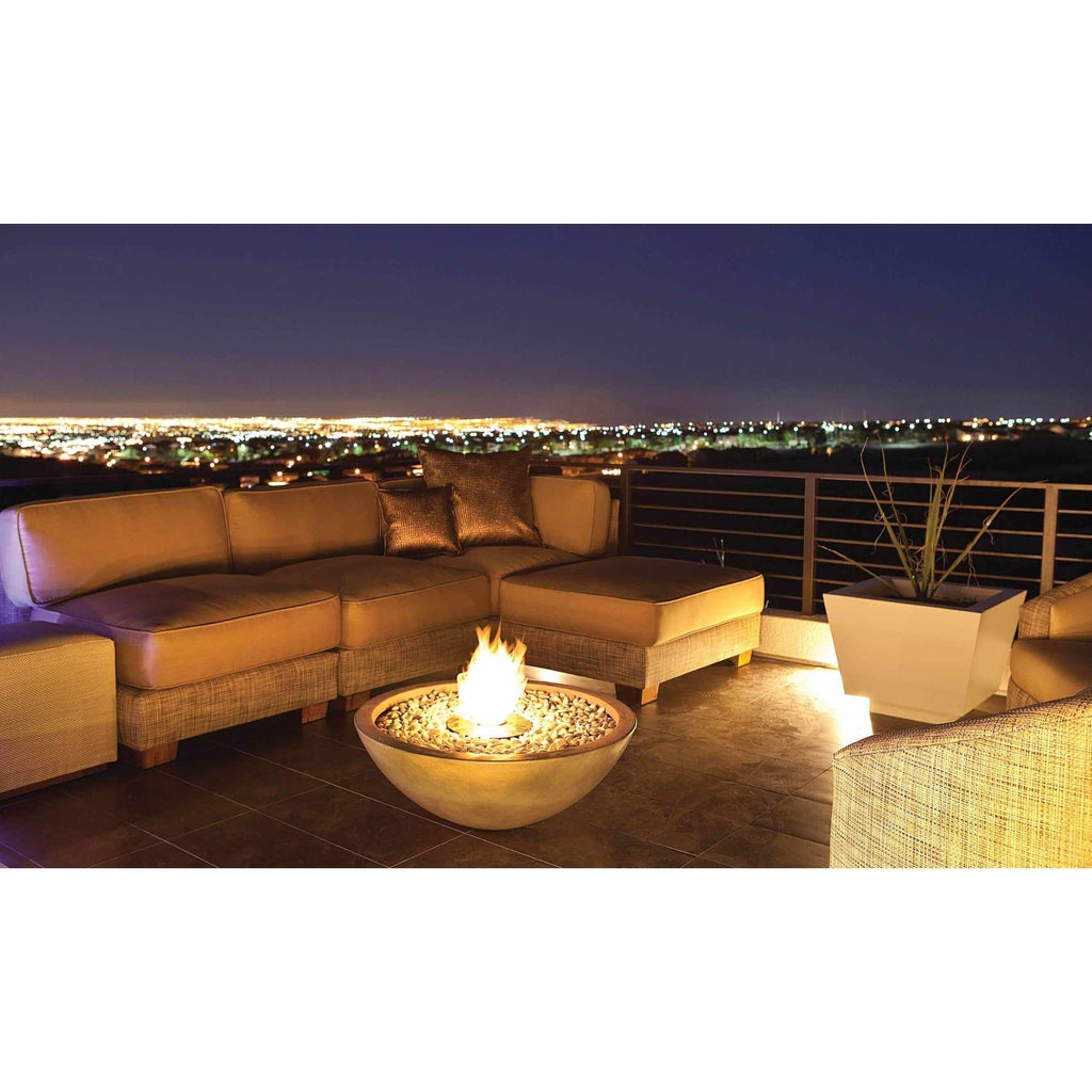 EcoSmart Fire Mix 850 bioethanol fire pit bowl with glowing flames on a modern terrace at night.