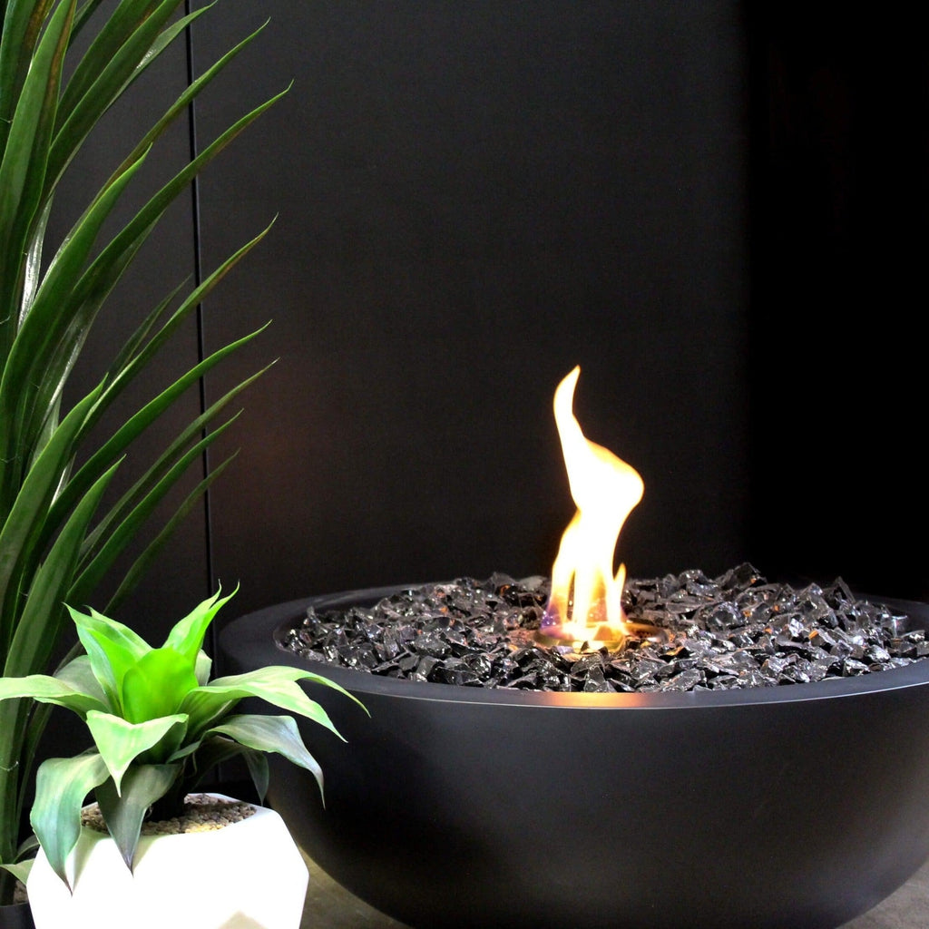 EcoSmart Fire Mix 850 bioethanol fire pit bowl in black with black glass decorative stones and a central flame.