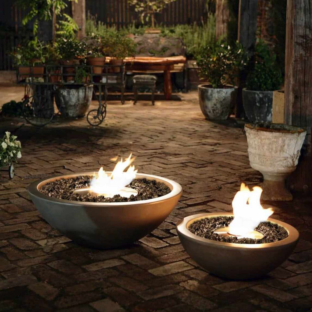 Two grey EcoSmart Fire Mix 850 bioethanol fire bowls with black glass media, glowing on a brick patio at night.
