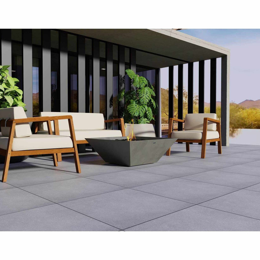 EcoSmart Fire Nova 850 bioethanol fire pit in a grey concrete finish on a modern patio with outdoor seating.