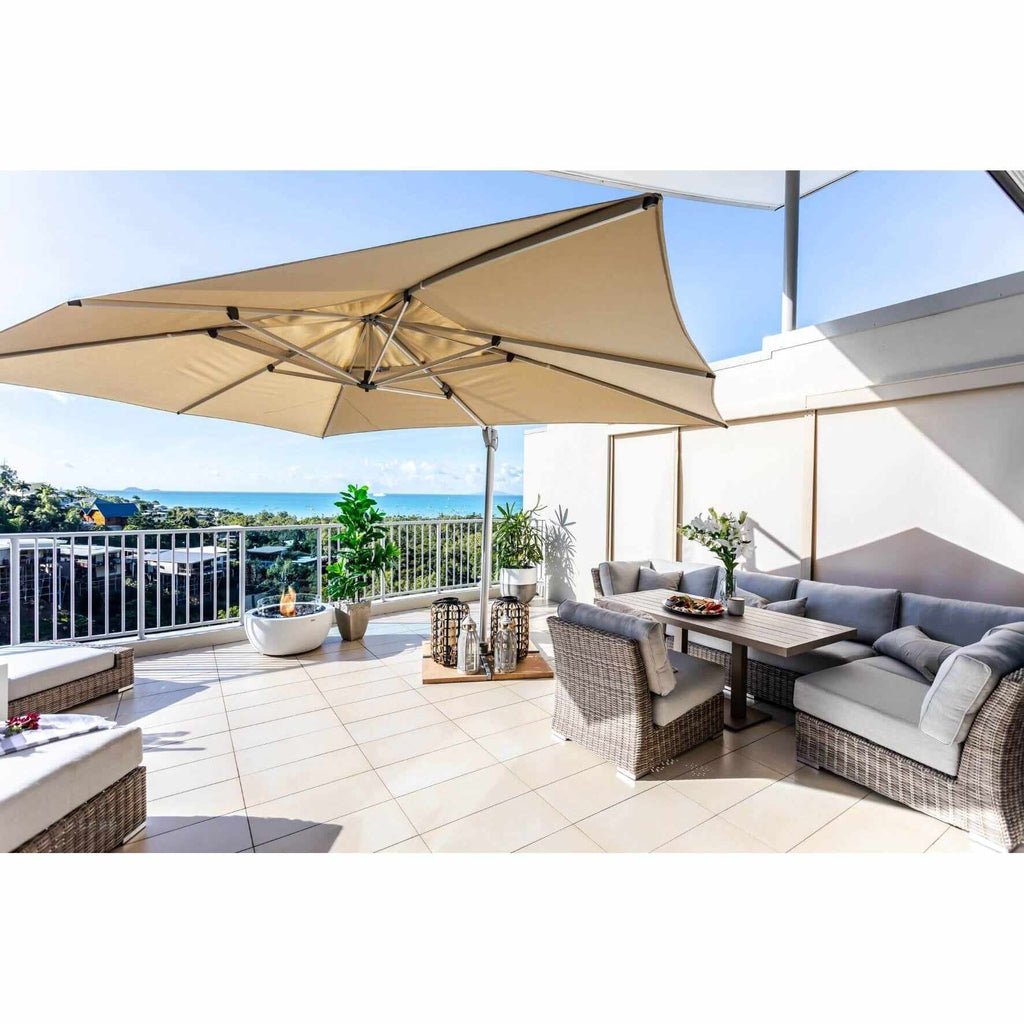 EcoSmart Fire Pod 30 bioethanol fire pit bowl in white, positioned on a sunny balcony with ocean views.