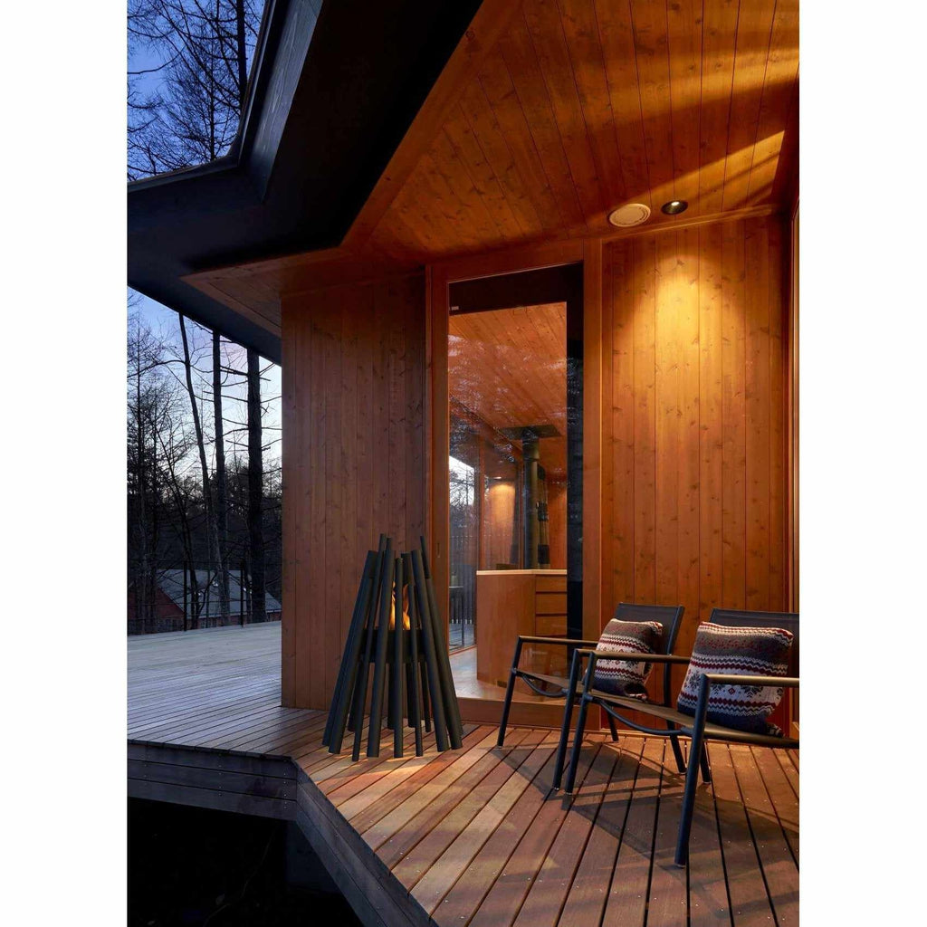 EcoSmart Fire Stix 8 bioethanol fire pit on a wooden deck with two chairs at dusk.