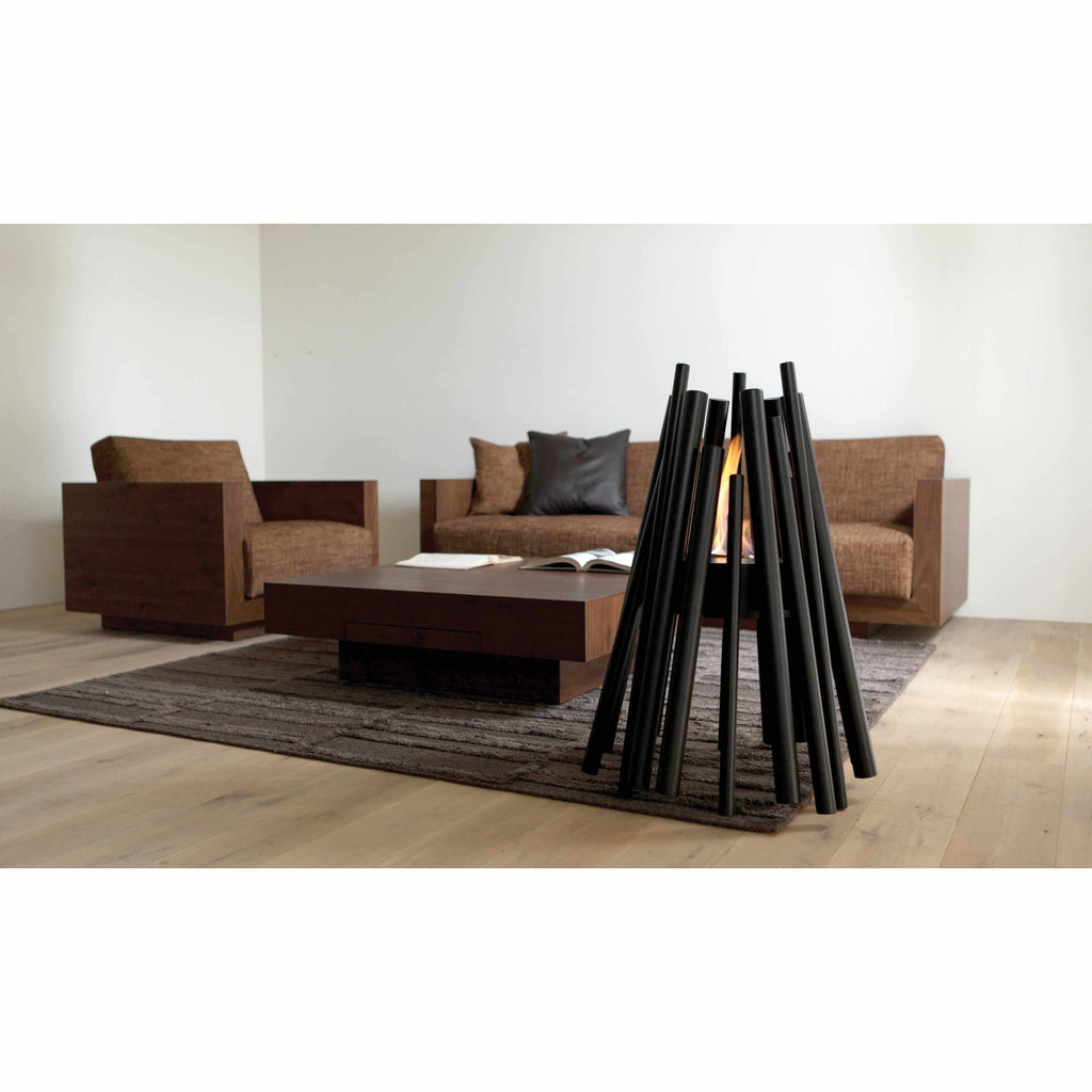 EcoSmart Fire Stix bioethanol fire pit with black metal rods arranged in a teepee shape, glowing with a central flame.