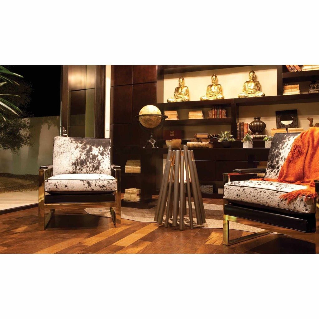 EcoSmart Fire Stix bioethanol fire pit with a metallic tubular design standing between two patterned armchairs.