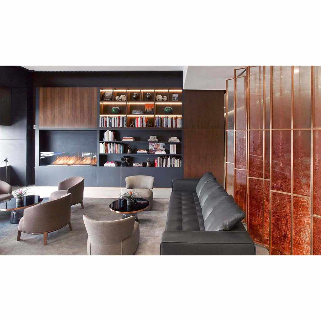 EcoSmart Fire XL500 ethanol burner integrated into a modern black fireplace wall within a contemporary living room.