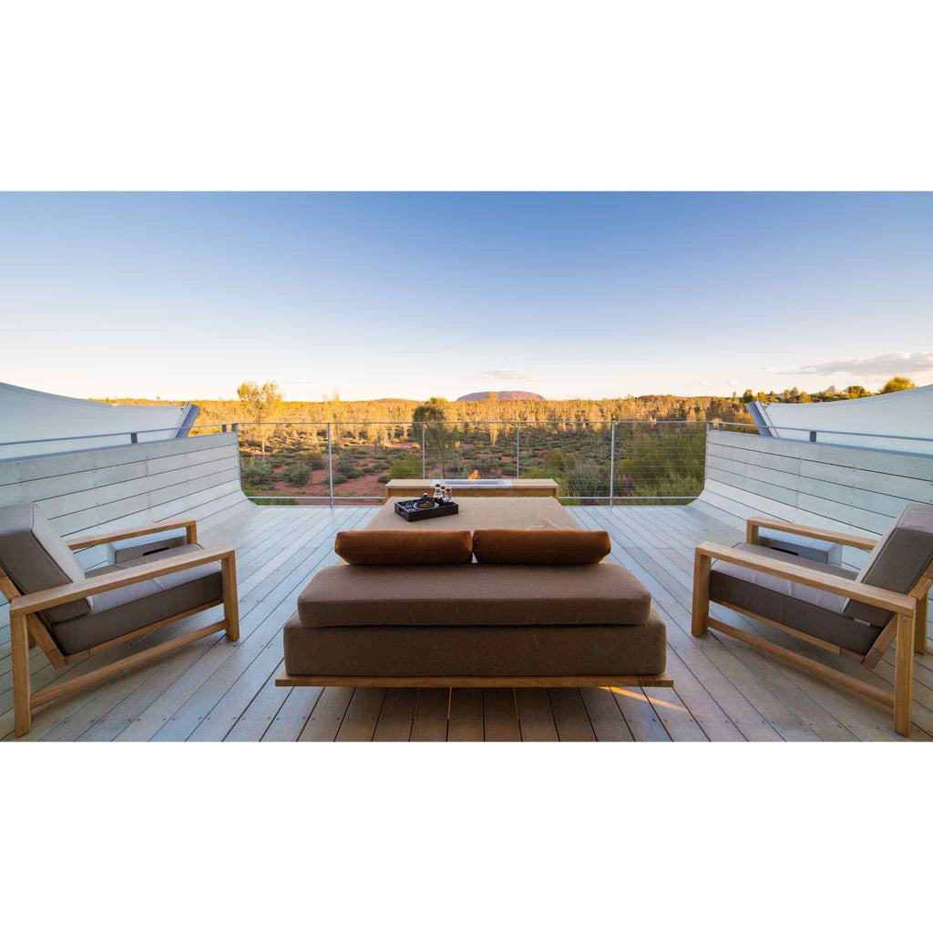 EcoSmart Fire XL700 ethanol burner integrated into a wooden deck with outdoor lounge furniture overlooking a desert.