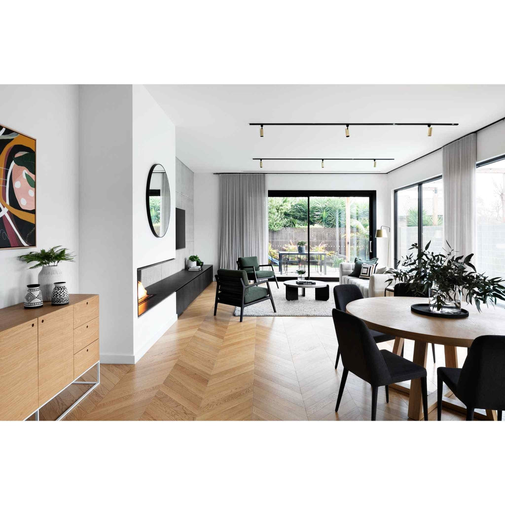EcoSmart Fire XL700 ethanol burner integrated into a sleek black wall unit within a modern, open-plan living room.