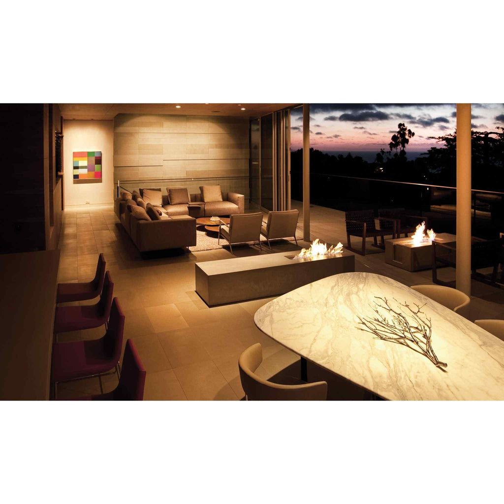 EcoSmart Fire XL700 ethanol burner integrated into a long concrete hearth in a modern, open-plan outdoor living space.