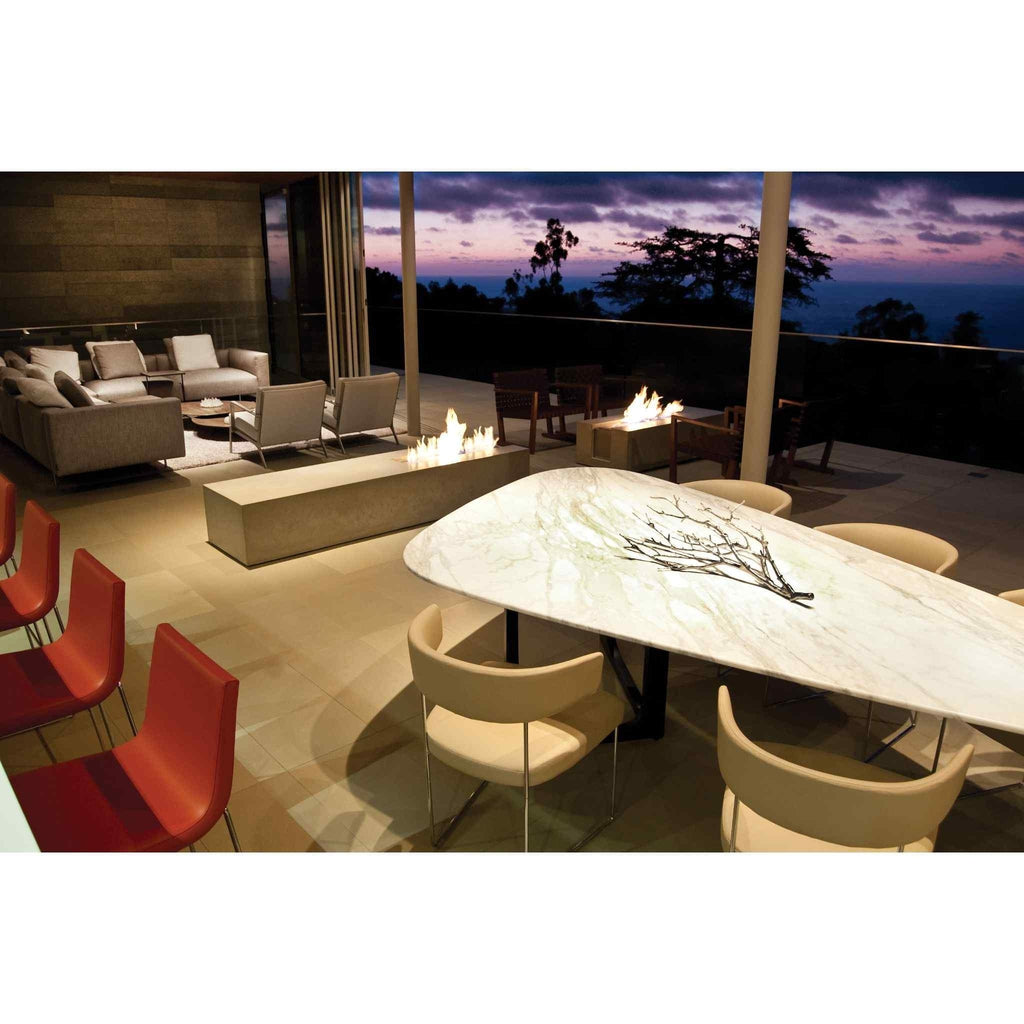 EcoSmart Fire XL700 ethanol burner integrated into a long, light grey concrete fire pit on an outdoor terrace.