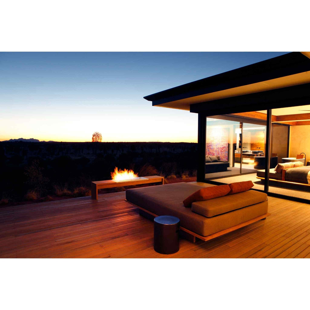 EcoSmart Fire XL700 ethanol burner integrated into a wooden bench on a sunset deck with outdoor furniture.