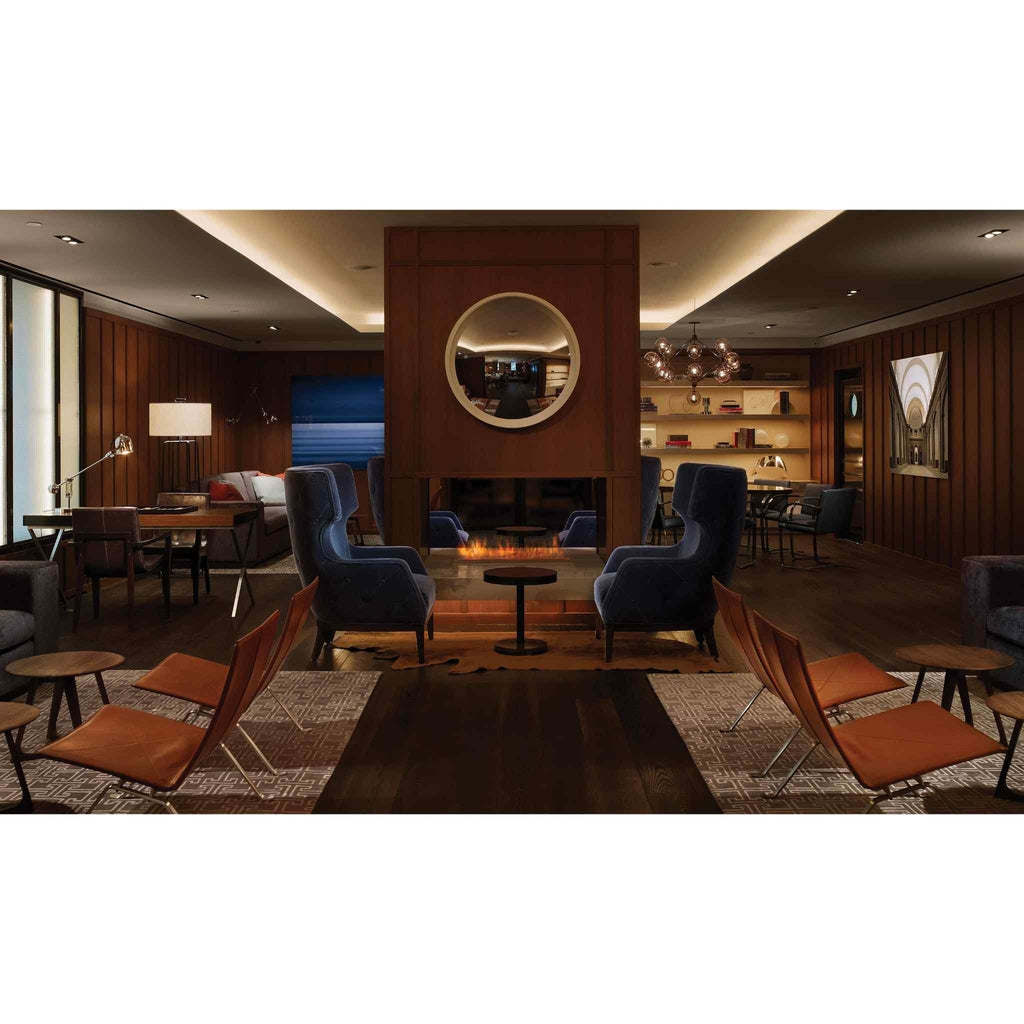 EcoSmart Fire XL700 ethanol burner integrated into a central fireplace within a sophisticated, wood-panelled lounge.