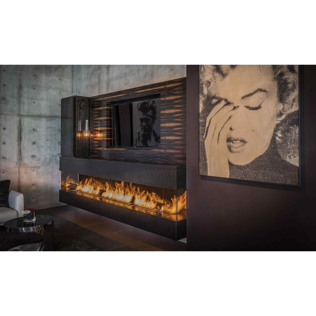 EcoSmart Fire XL900 ethanol burner integrated into a long, black floating fireplace beneath a wall-mounted television.