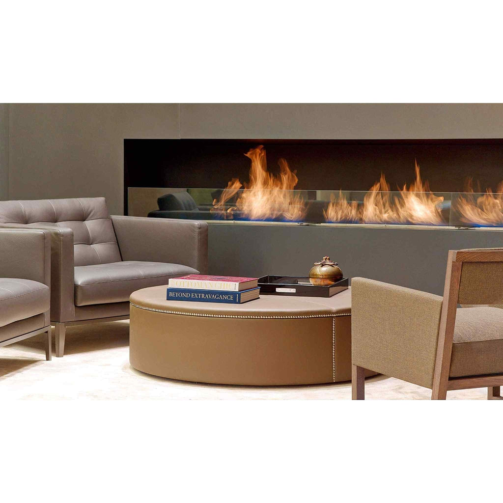 EcoSmart Fire XL900 ethanol burner installed in a long, linear wall recess with a glass screen and vibrant orange flames.