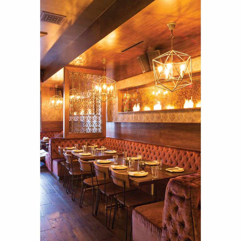EcoSmart Fire XS340 ethanol burner integrated into a restaurant wall above velvet booth seating.