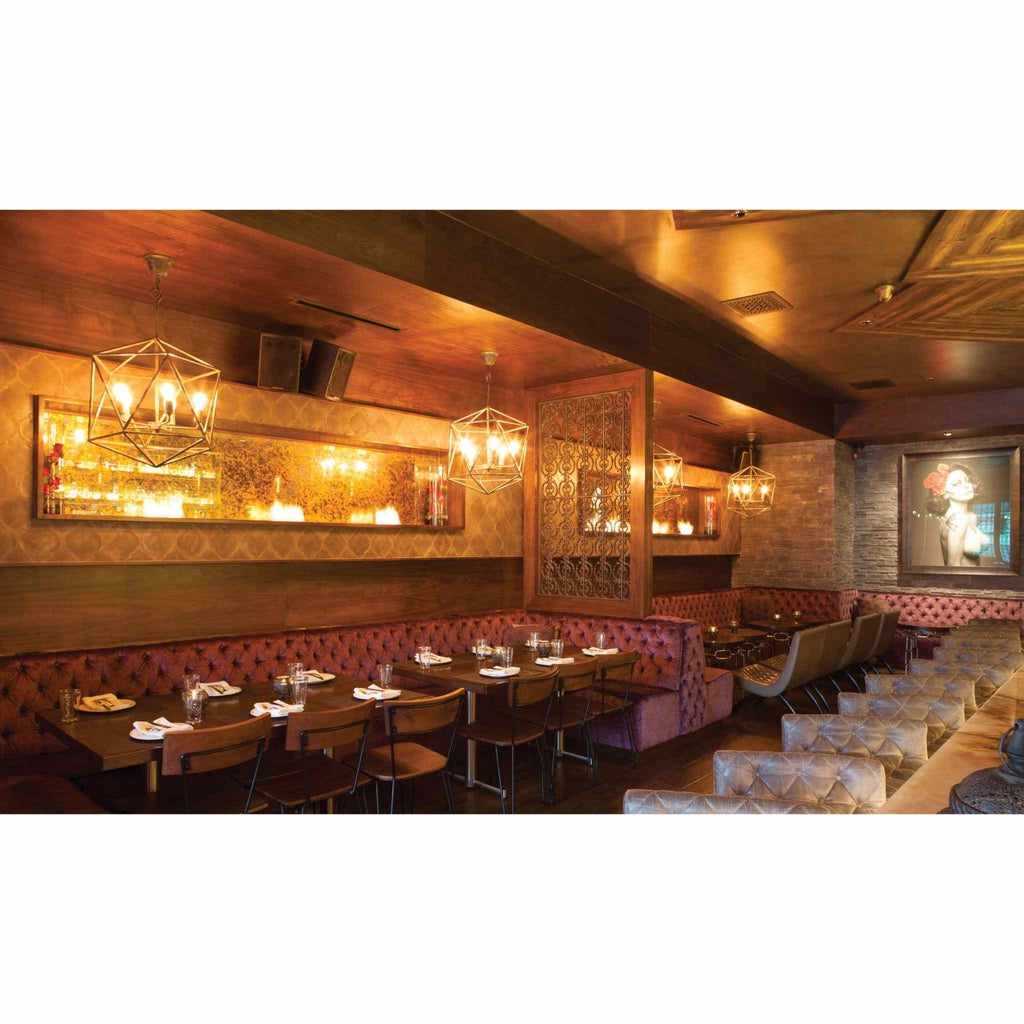 EcoSmart Fire XS340 ethanol burner integrated into a warm, wood-panelled restaurant wall with ambient lighting.