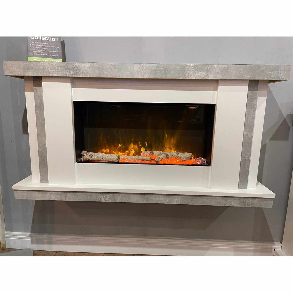Flametek Juno Electric Fireplace Suite with a white frame, grey concrete-effect mantel, and glowing log fire effect.