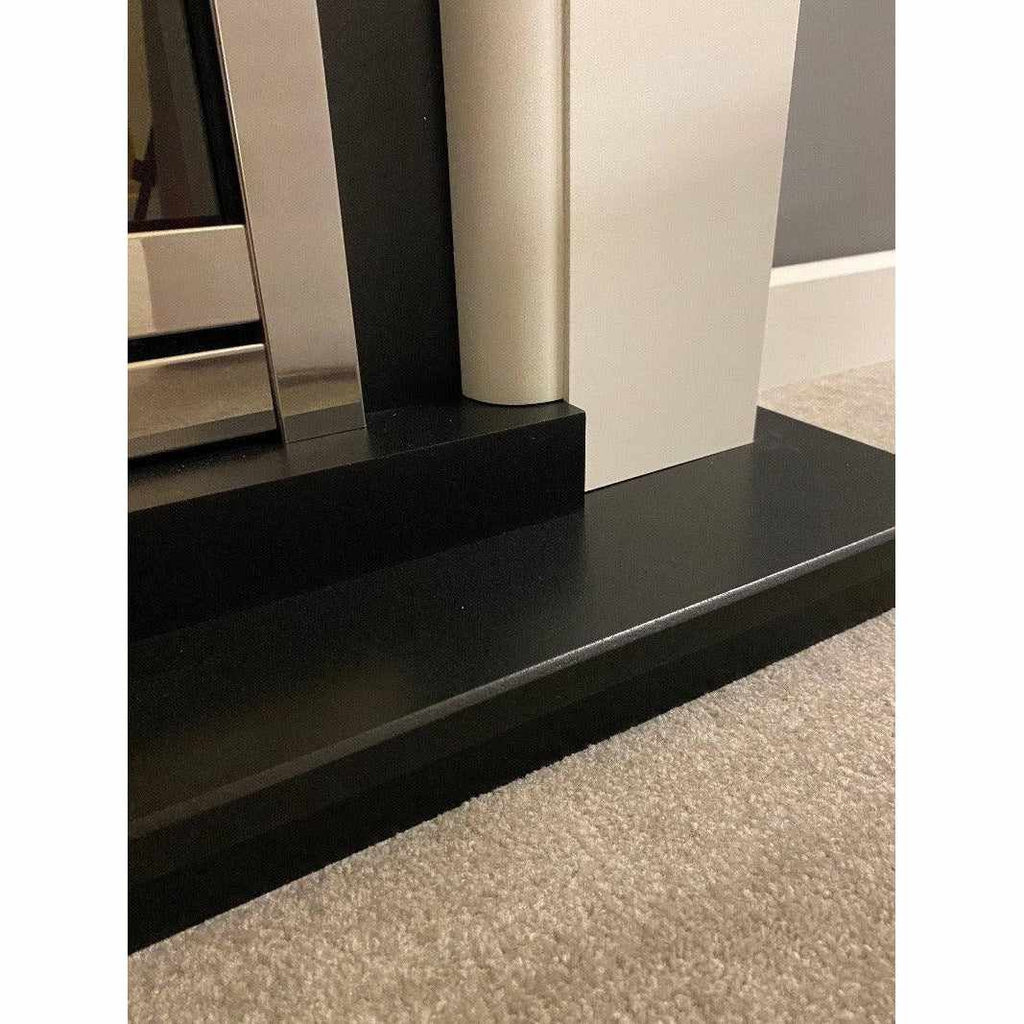 Suncrest Antigua Electric Fireplace suite featuring a black hearth, white surround, and silver fire trim.