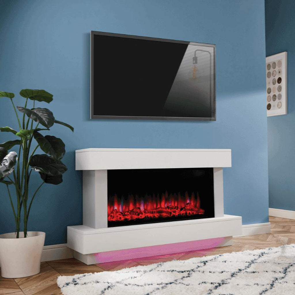Suncrest Bourne electric fireplace suite in white with a glowing red flame effect and pink under-plinth lighting.