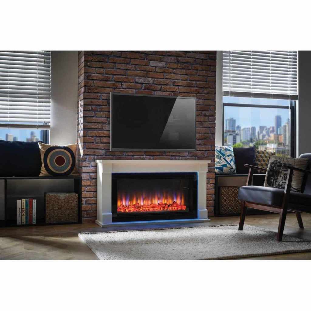 Suncrest Bradbury Ambience electric fireplace suite with a white surround and glowing flame effect against a brick wall.