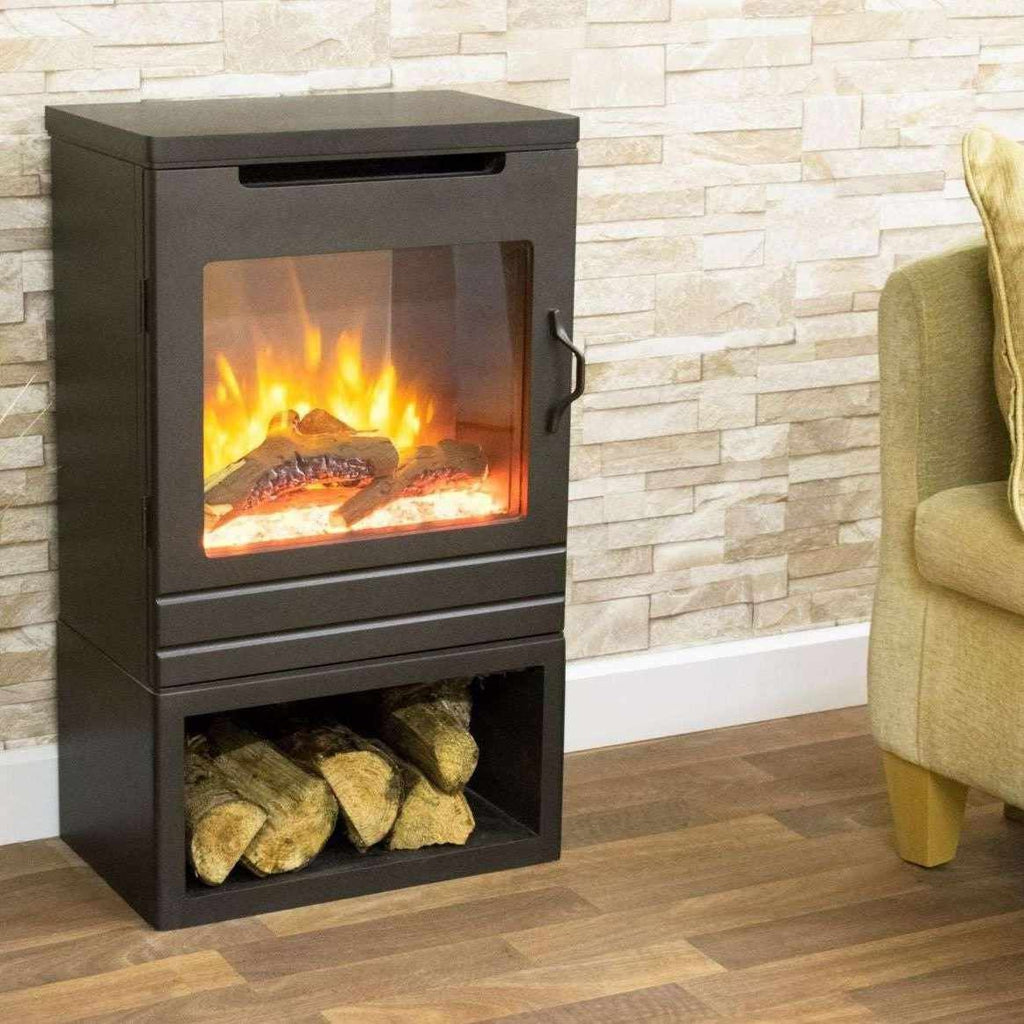 Suncrest Matfen electric stove in black with a log storage base and realistic flame effect against a stone wall.