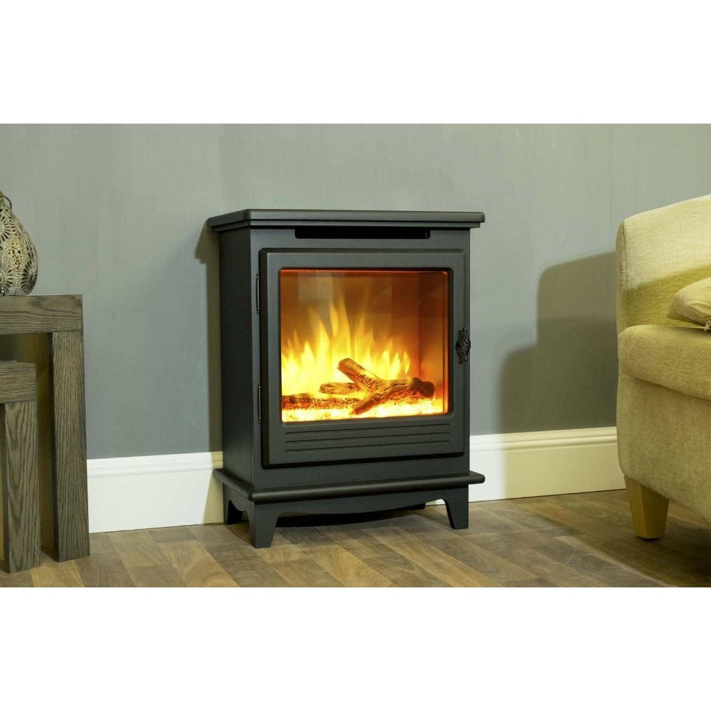 Suncrest Morpeth electric stove in matte black with a realistic log flame effect, standing on a wooden floor.